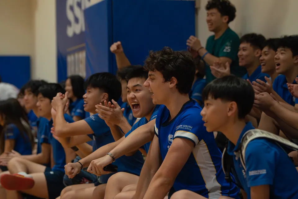 Bench players leaping up to celebrate