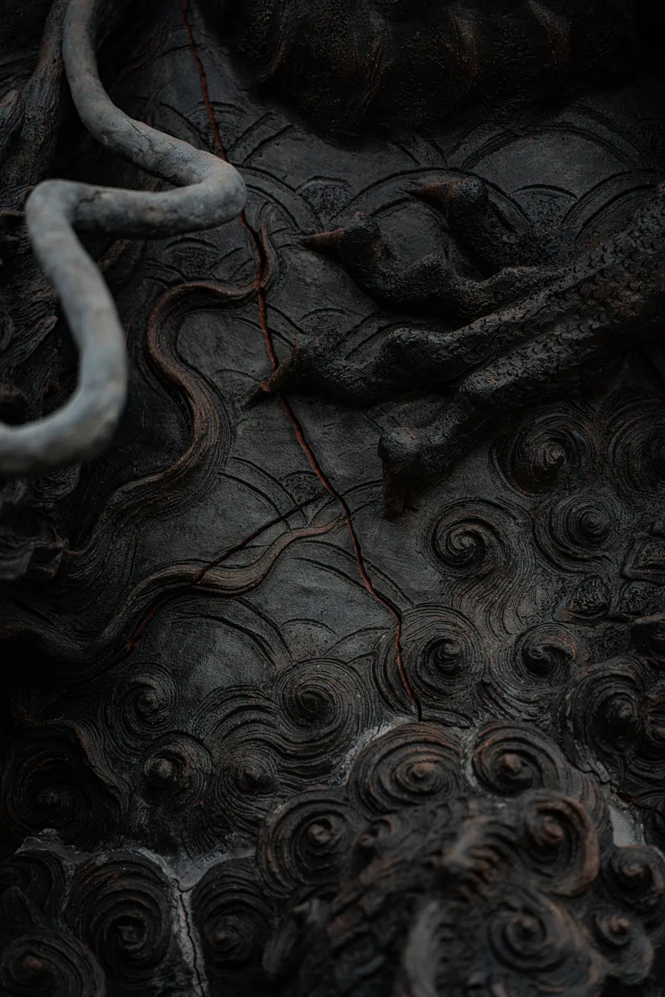 Weathered carved dragon relief, cracked with age